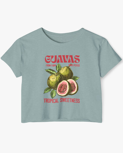Flat lay of a stonewash green crop top with a retro commercial guavas fruit graphic.