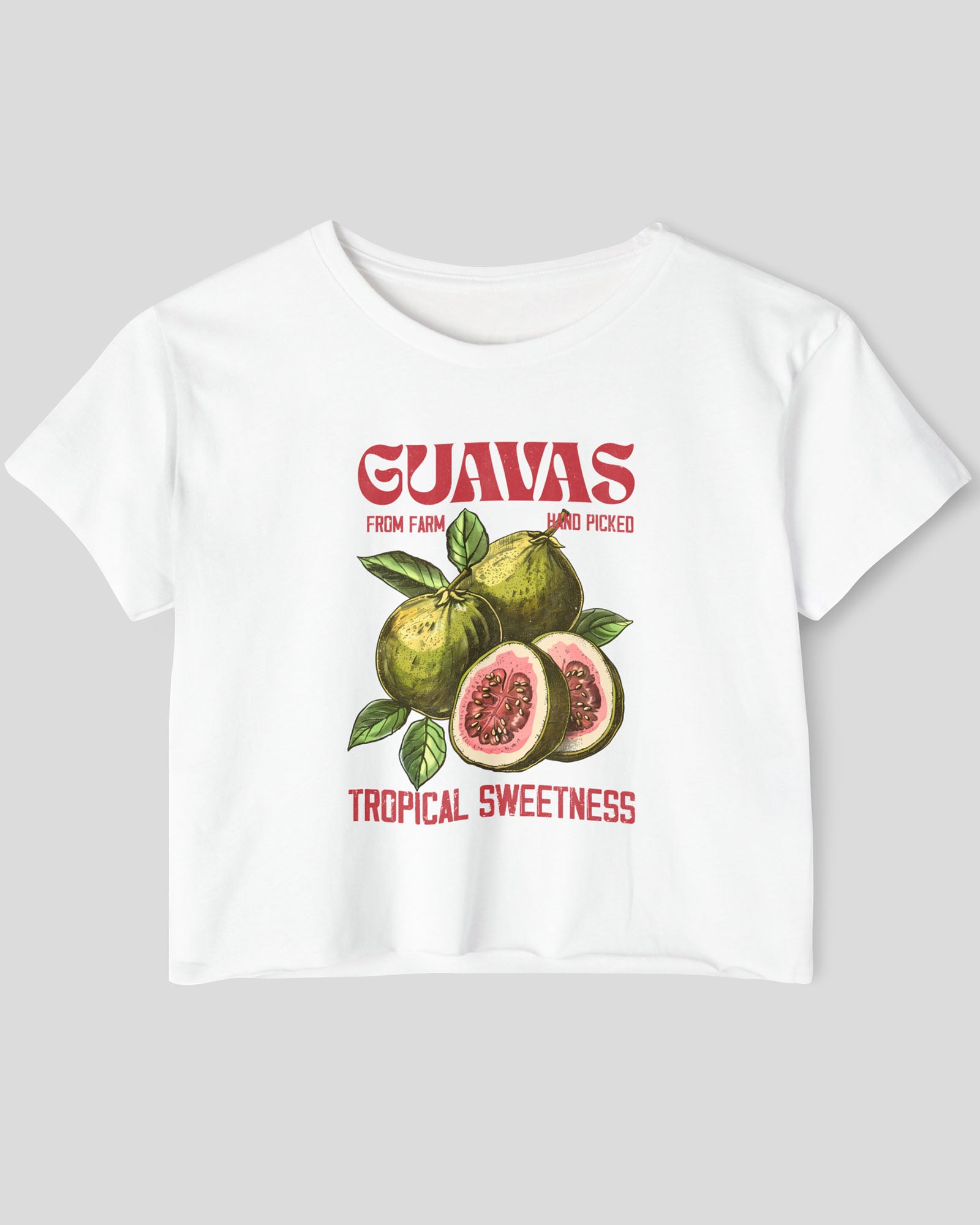 Flat lay of a white crop top with a retro commercial guavas fruit graphic.