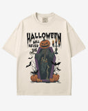 Halloween Will Never Die shirt in ivory with retro graphic of skeleton with pumpkin head climbing out of coffin.