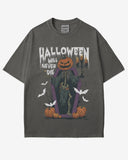 Halloween Will Never Die shirt in pepper with retro graphic of skeleton with pumpkin head climbing out of coffin.