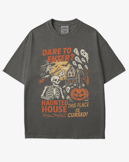 Flat lay pepper "Dare To Enter? - Haunted House" shirt with a retro Halloween graphic of a haunted house, witch, skeletons, and ghosts.
