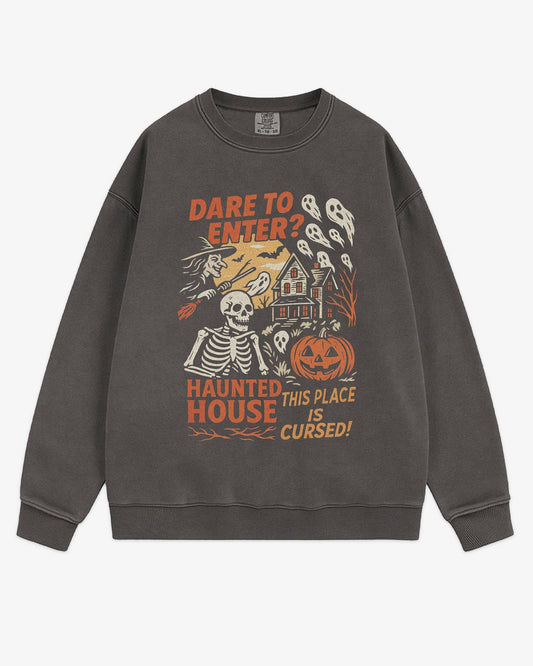 Flat lay pepper Halloween sweatshirt reading ‘Dare To Enter – Haunted House’ with retro graphic of haunted house, skeletons, and a witch.