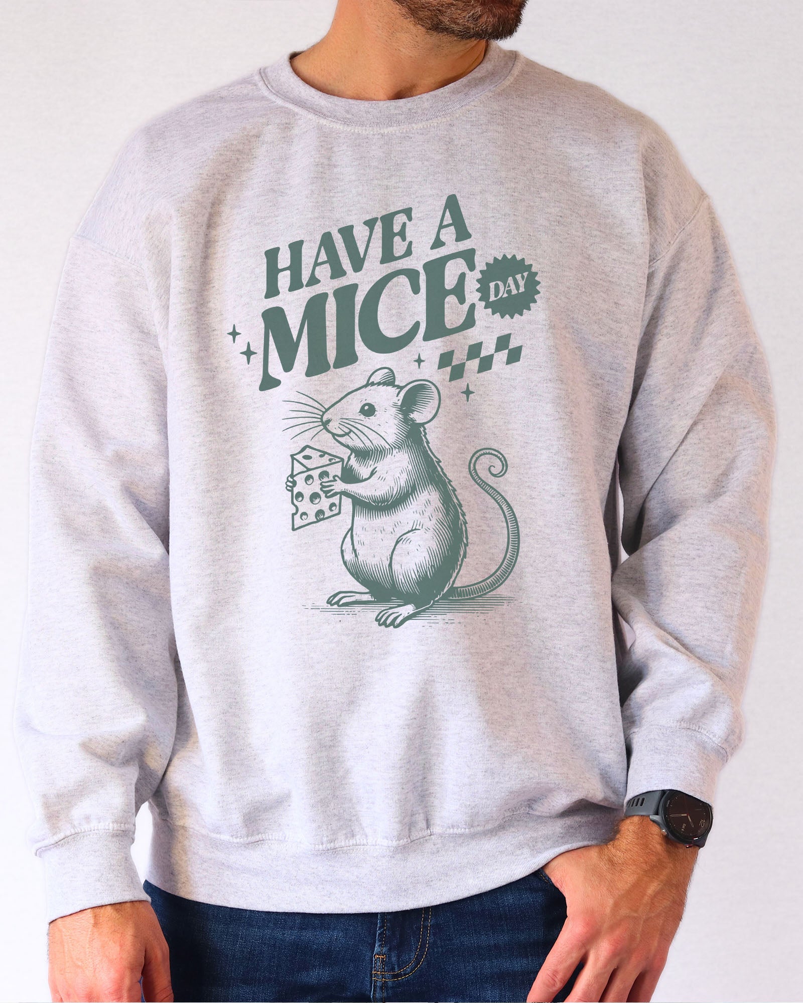 Model wearing ash color sweatshirt with 'Have A Mice Day' graphic design