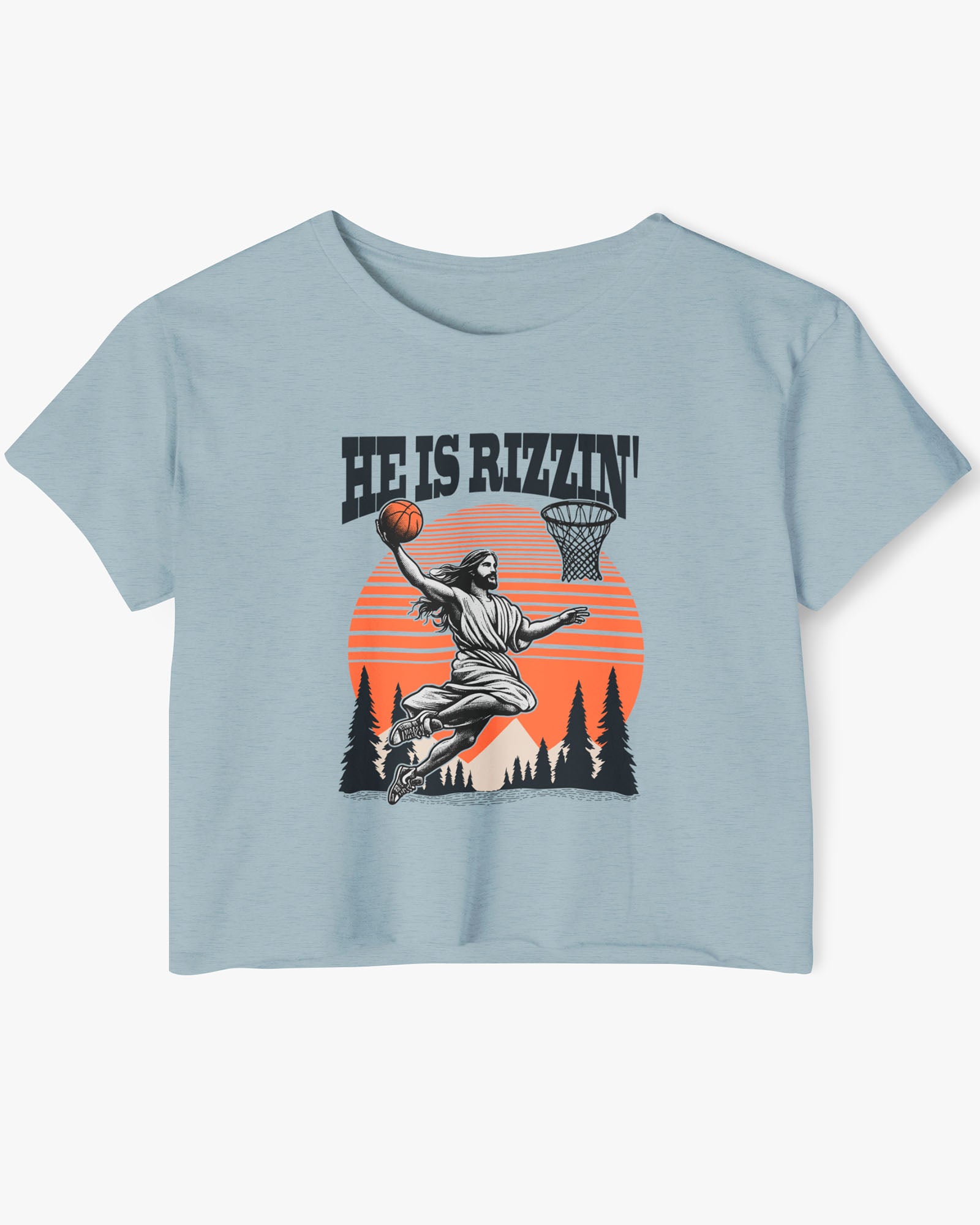 Flat lay of a stonewash denim 'He Is Rizzin' crop top featuring a funny retro graphic of Jesus slam-dunking a basketball.