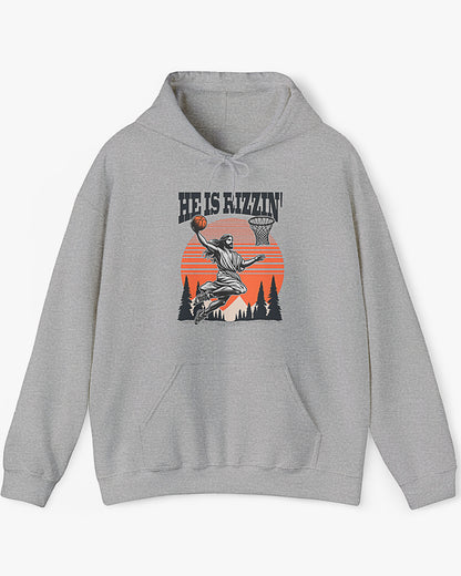 Flat laying sport gray 'He Is Rizzin' hoodie featuring retro Jesus dunking basketball graphic, ideal for Easter.