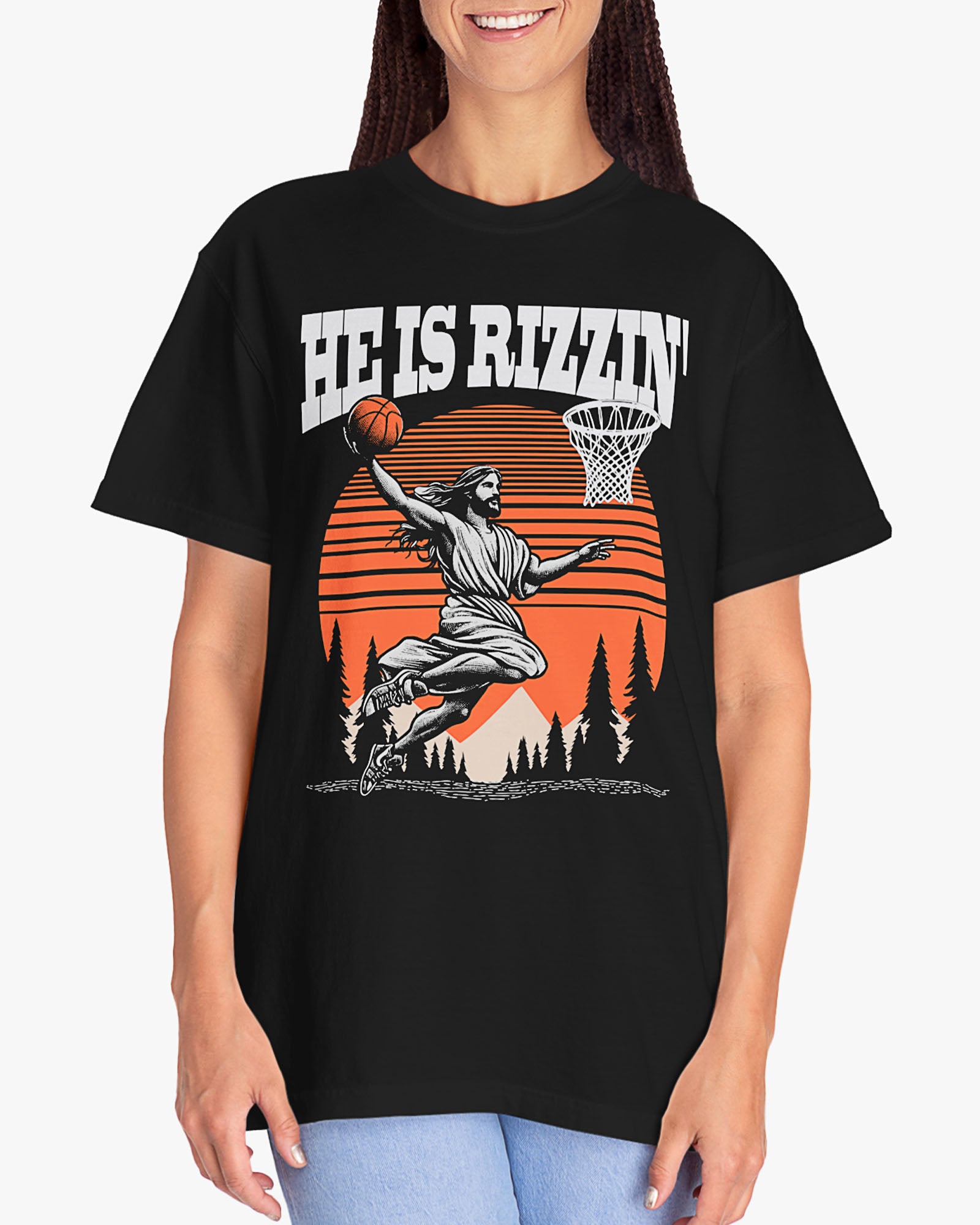 Woman wearing 'He Is Rizzin' tee in black color with Jesus playing basketball graphic