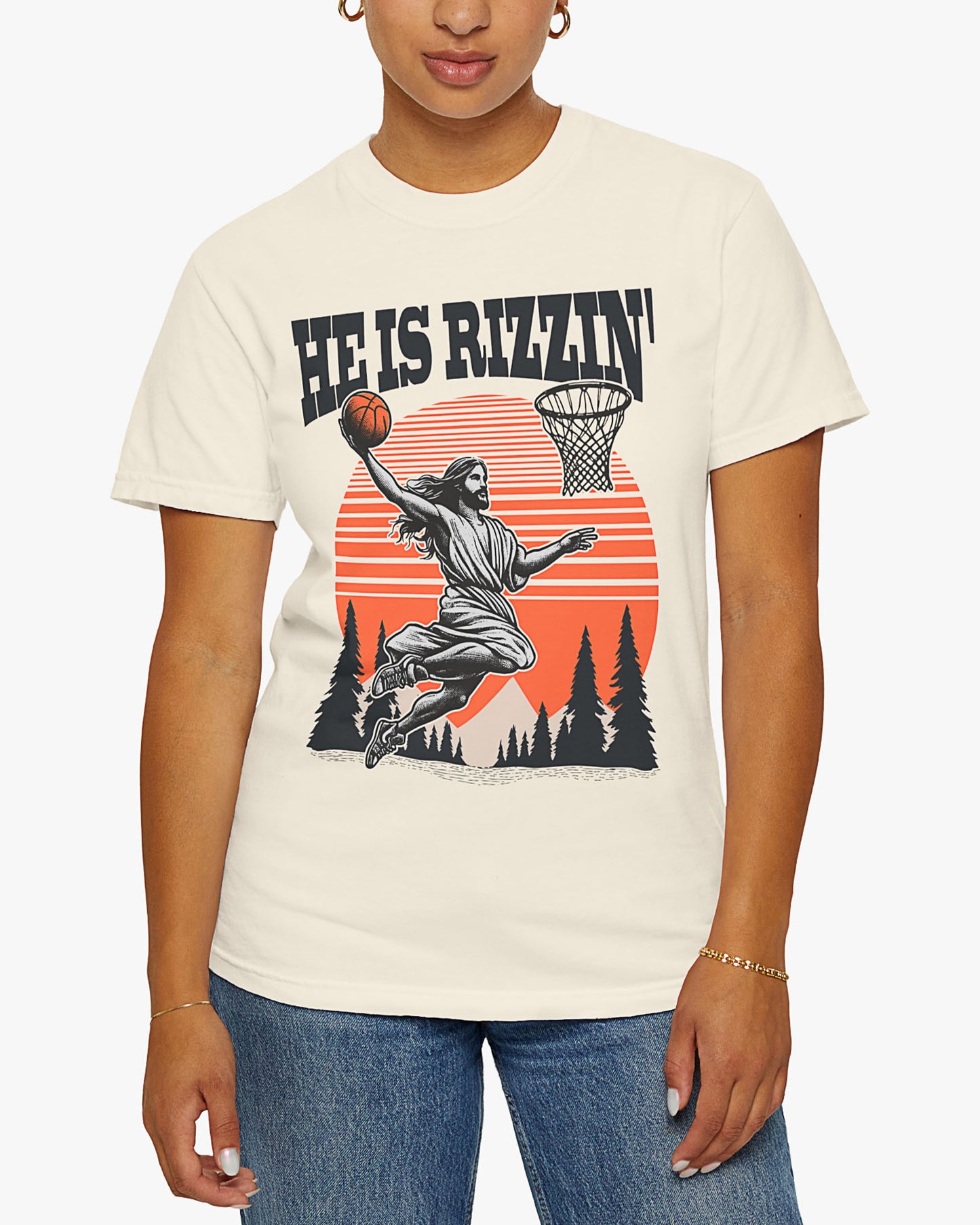 Woman wearing 'He Is Rizzin' tee in natural color with Jesus playing basketball graphic