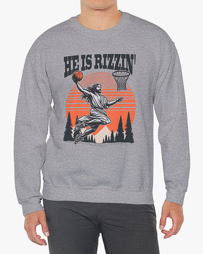 Man wearing sport gray 'He Is Rizzin' sweatshirt with retro Jesus dunking basketball graphic, perfect for Easter and funny Y2K style.
