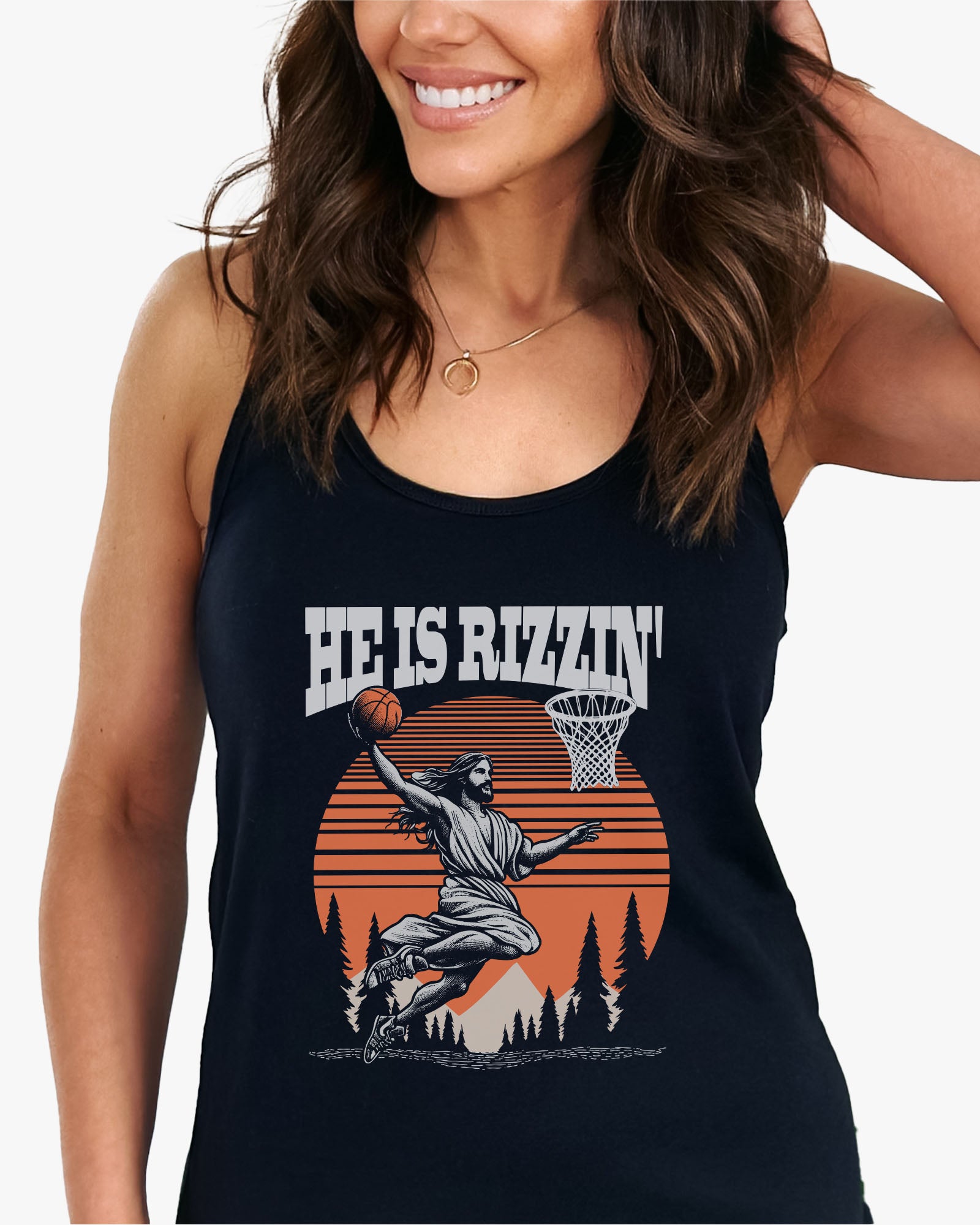 Woman wearing 'He Is Rizzin' tank top in black featuring a funny retro graphic of Jesus dunking a basketball, perfect for summer style and humor.