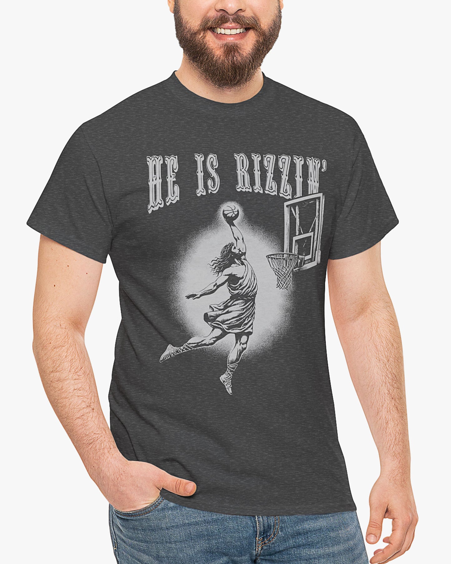 Man is wearing He is Rizzin' tee in dark heather color with funny Jesus dunking a basketball graphic