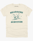 Flat laying natural beige color 'Headache Survivor' shirt featuring a funny retro bunny with a headache graphic.