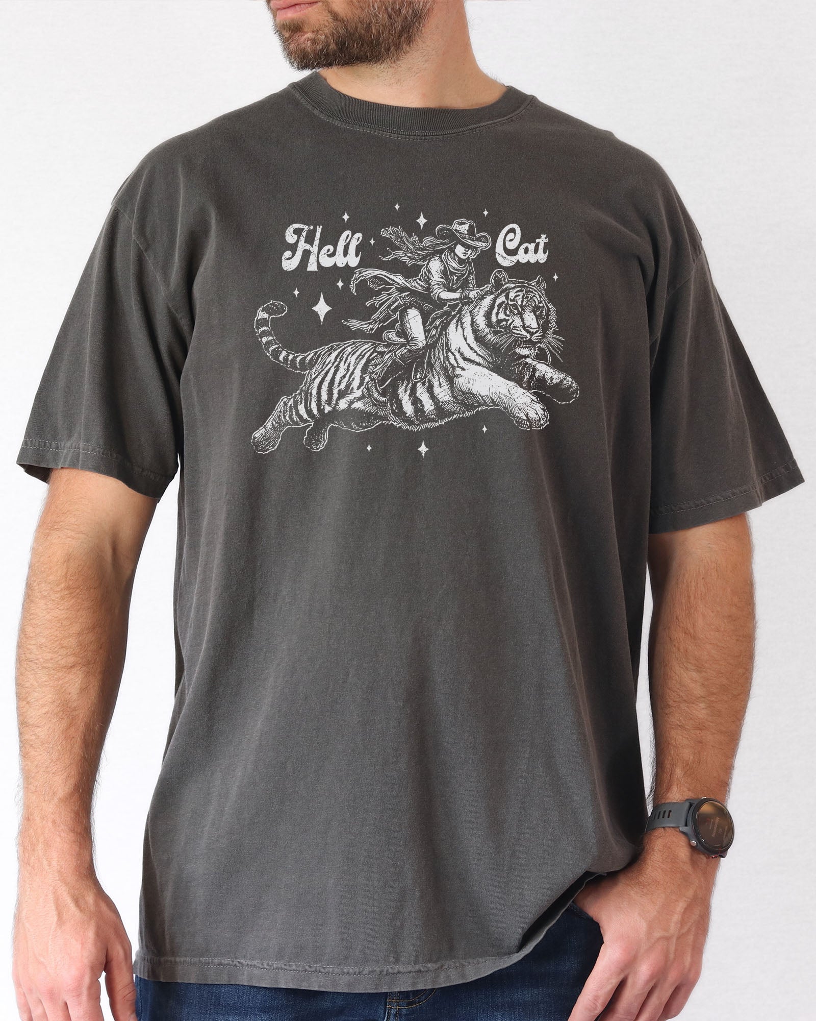 Man  wearing a pepper "Hell Cat" shirt with a retro graphic of a cowgirl riding a tiger.