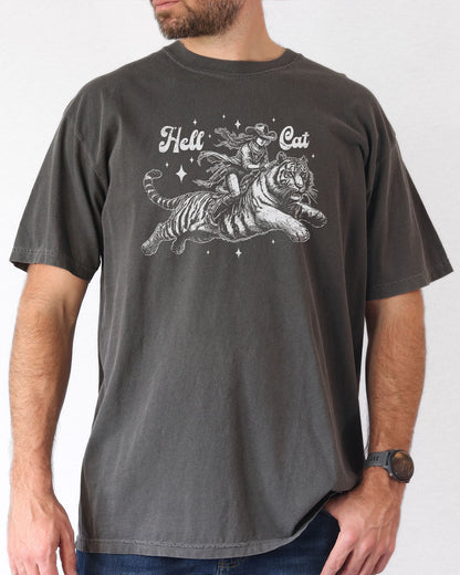 Man  wearing a pepper "Hell Cat" shirt with a retro graphic of a cowgirl riding a tiger.