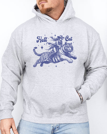 Man wearing an ash-colored hoodie featuring a retro cowgirl riding a tiger graphic, titled 'Hell Cat'.