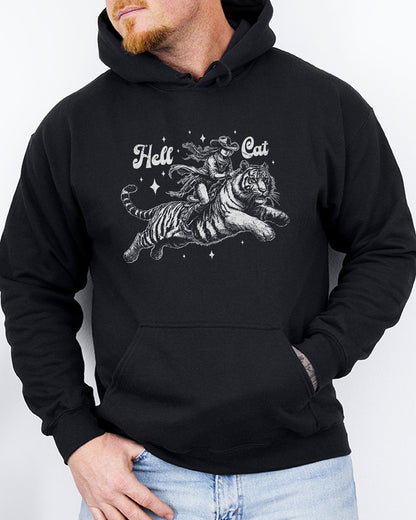 Man wearing a black-colored hoodie featuring a retro cowgirl riding a tiger graphic, titled 'Hell Cat'.