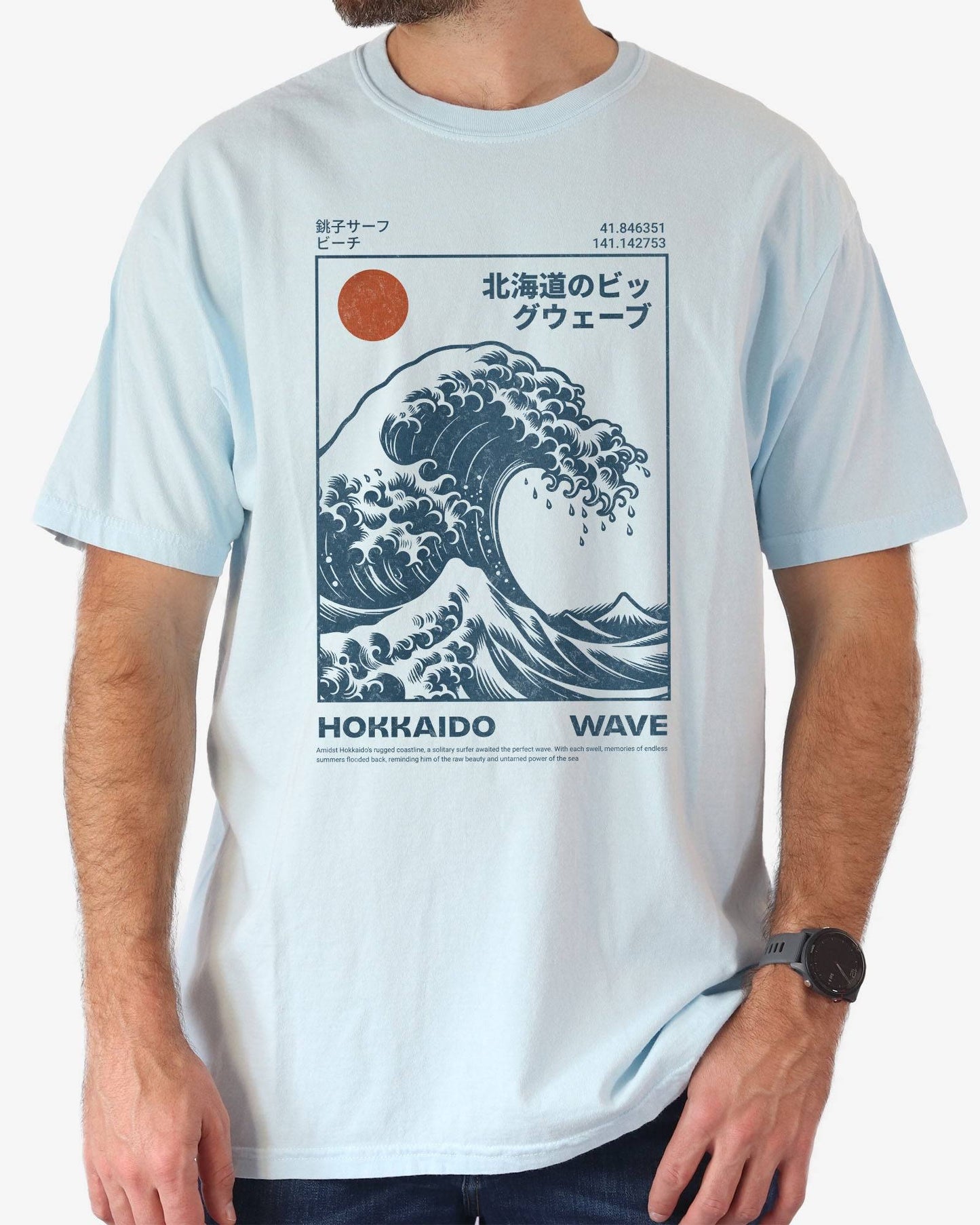 Man wearing a chambray ‘Hokkaido Wave’ surf shirt with a retro Japanese great wave graphic in traditional ukiyo-e style.