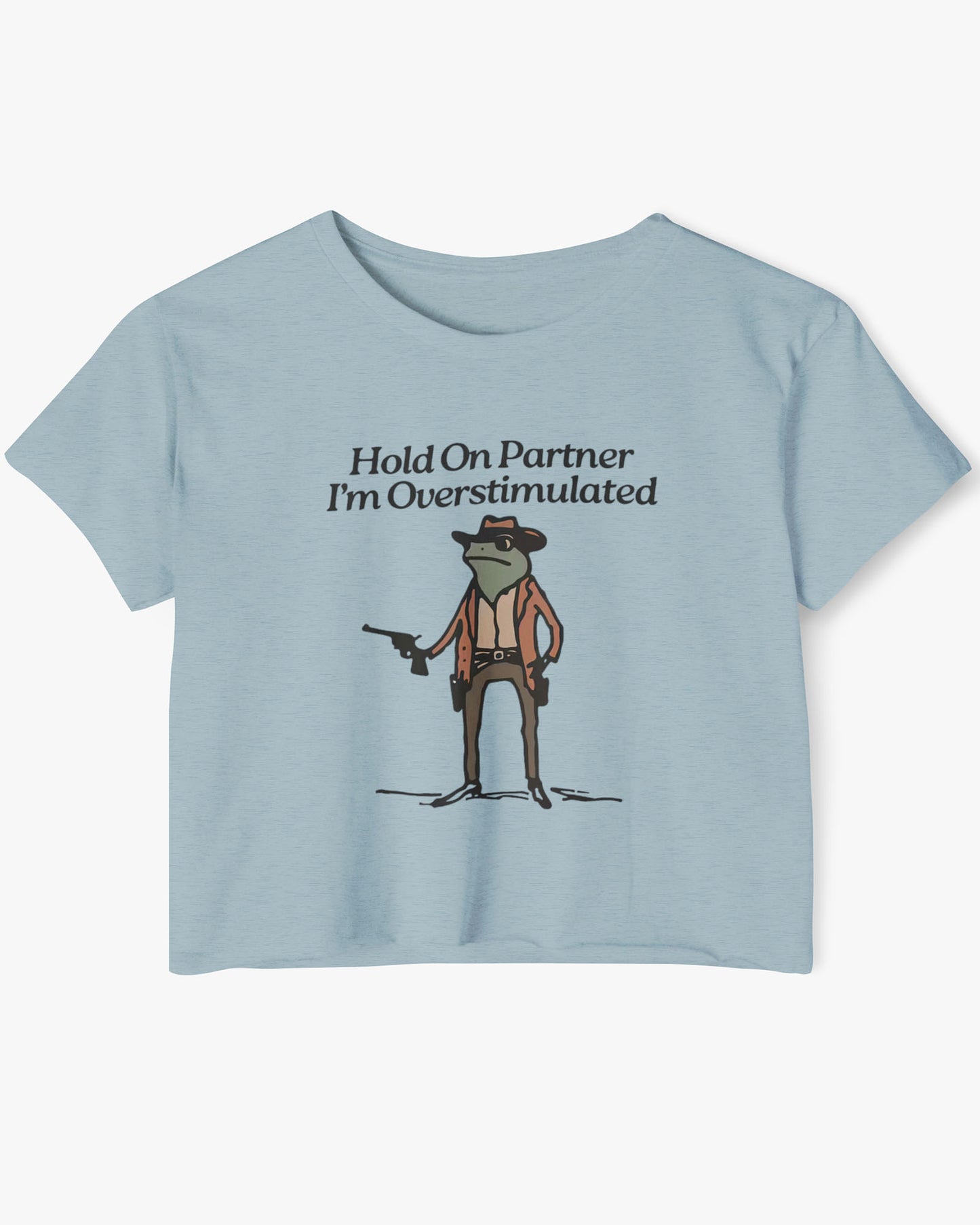 Flat lay stonewash denim 'Hold On Partner, I'm Overstimulated' crop top featuring a funny retro cowboy frog graphic.