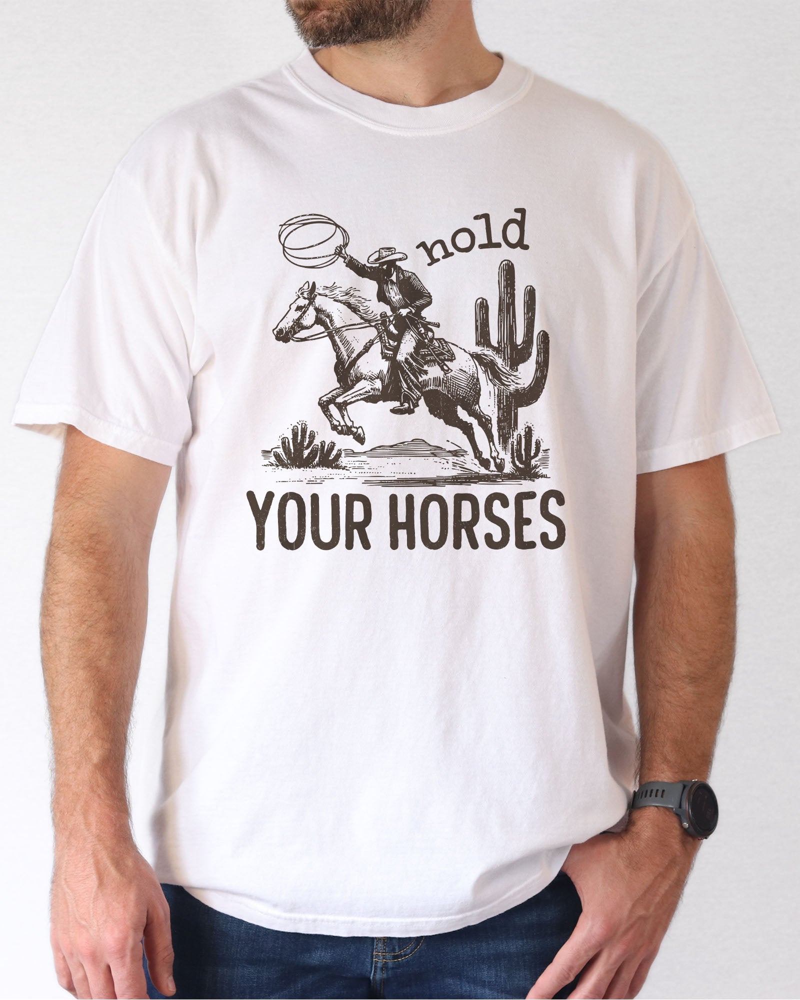 Man wearing white color shirt with 'Hold Your Horses' graphic design