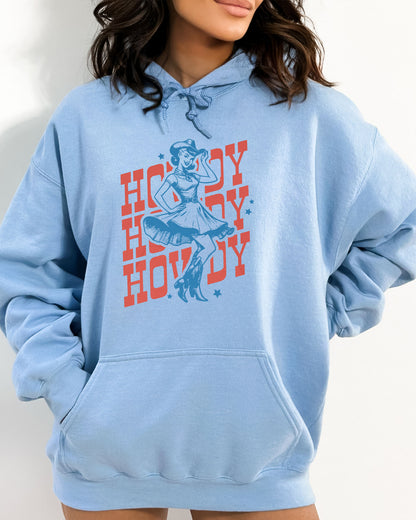 Woman wearing a light blue hoodie with a retro howdy cowgirl graphic.