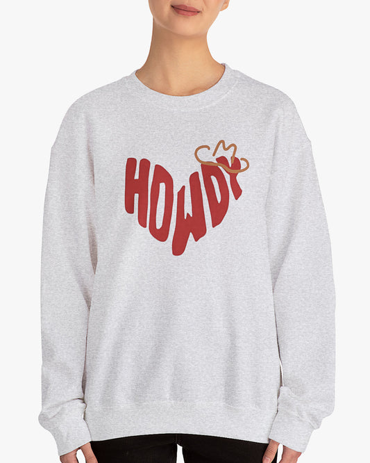 Woman wearing ash gray sweatshirt with retro western 'Howdy' text shaped as a heart graphic.