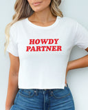Woman wearing a white 'Howdy Partner' crop top.