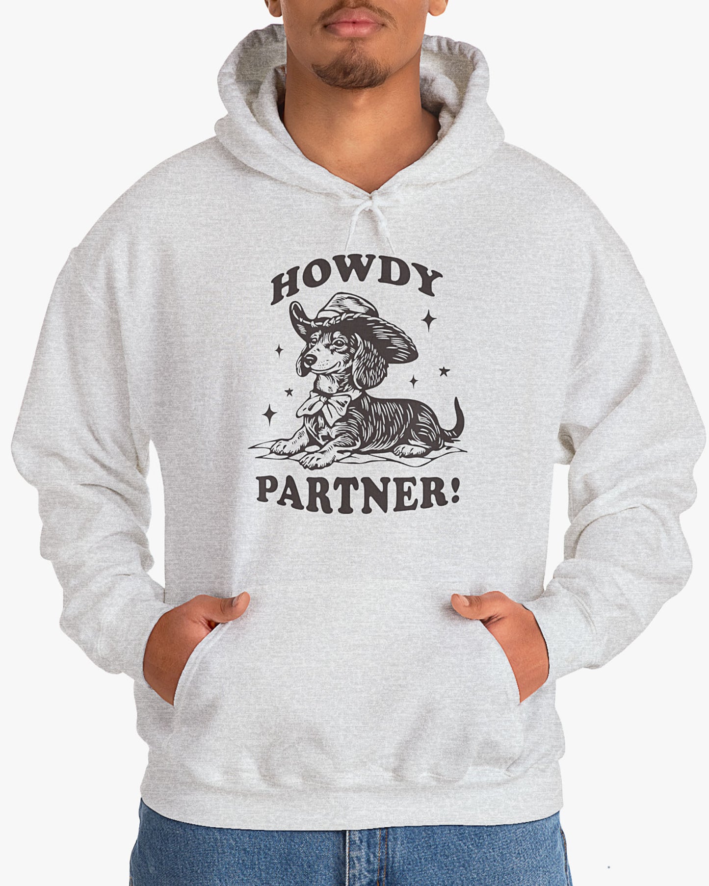 Man wearing ash gray 'Howdy Partner' hoodie with funny retro cowboy dachshund graphic