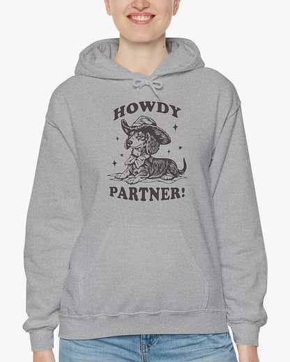 Woman wearing sport gray 'Howdy Partner' hoodie with funny retro cowboy dachshund graphic