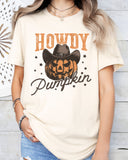 Model wearing natural color shirt with 'Howdy Pumpkin' Halloween graphic design