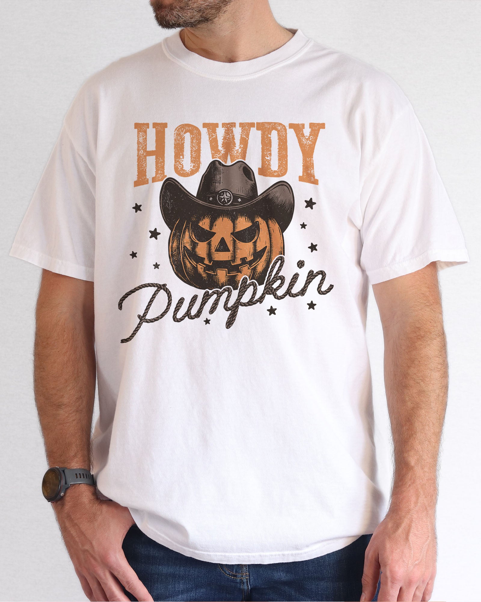 Model wearing white color shirt with 'Howdy Pumpkin' Halloween graphic design