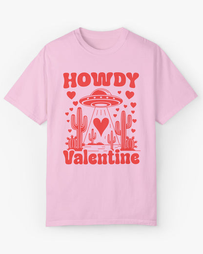 Flat lay light pink 'Howdy Valentine' shirt featuring a funny retro western landscape graphic with a UFO