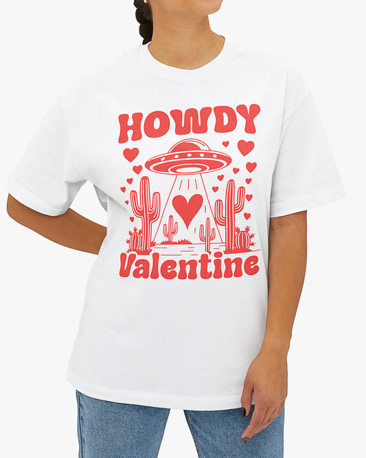 Woman wearing a white 'Howdy Valentine' shirt featuring a funny retro western landscape graphic with a UFO