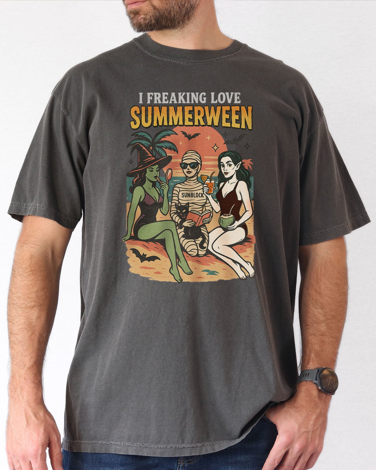 man wearing a pepper "I Freaking Love Summerween" shirt with a retro graphic of two witches and a mummy relaxing on the beach.