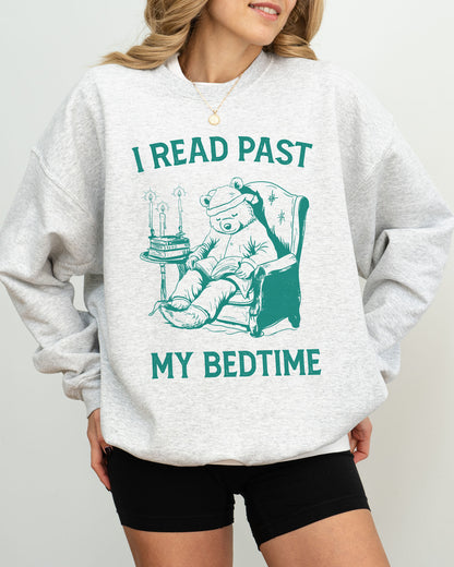 Model wearing ash color sweatshirt with 'I Read Past my Bedtime' graphic design