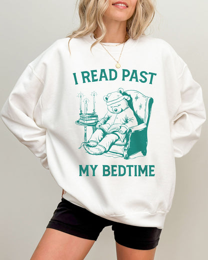 Model wearing white color sweatshirt with 'I Read Past my Bedtime' graphic design