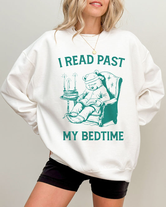 Model wearing white color sweatshirt with 'I Read Past my Bedtime' graphic design