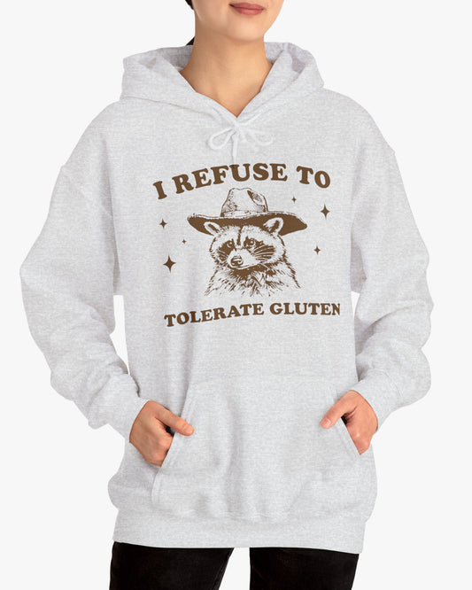 Woman wearing an 'I Refuse To Tolerate Gluten' hoodie in ash gray, featuring a retro western graphic design and unisex fit.