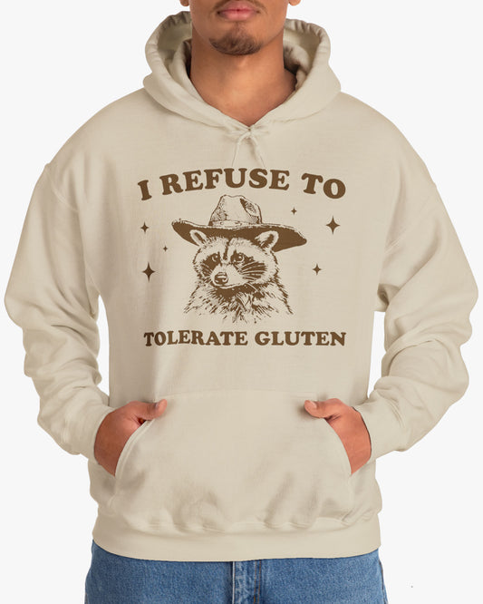 Man wearing an 'I Refuse To Tolerate Gluten' hoodie in sand beige, featuring a retro western graphic design and unisex fit.