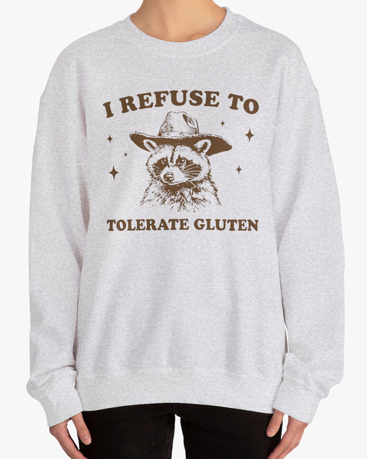 Woman wearing an 'I Refuse To Tolerate Gluten' sweatshirt in ash gray, featuring a retro cowboy raccoon graphic design and unisex fit.