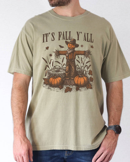 Model wearing khaki color shirt with 'It's Fall Y'all' graphic design