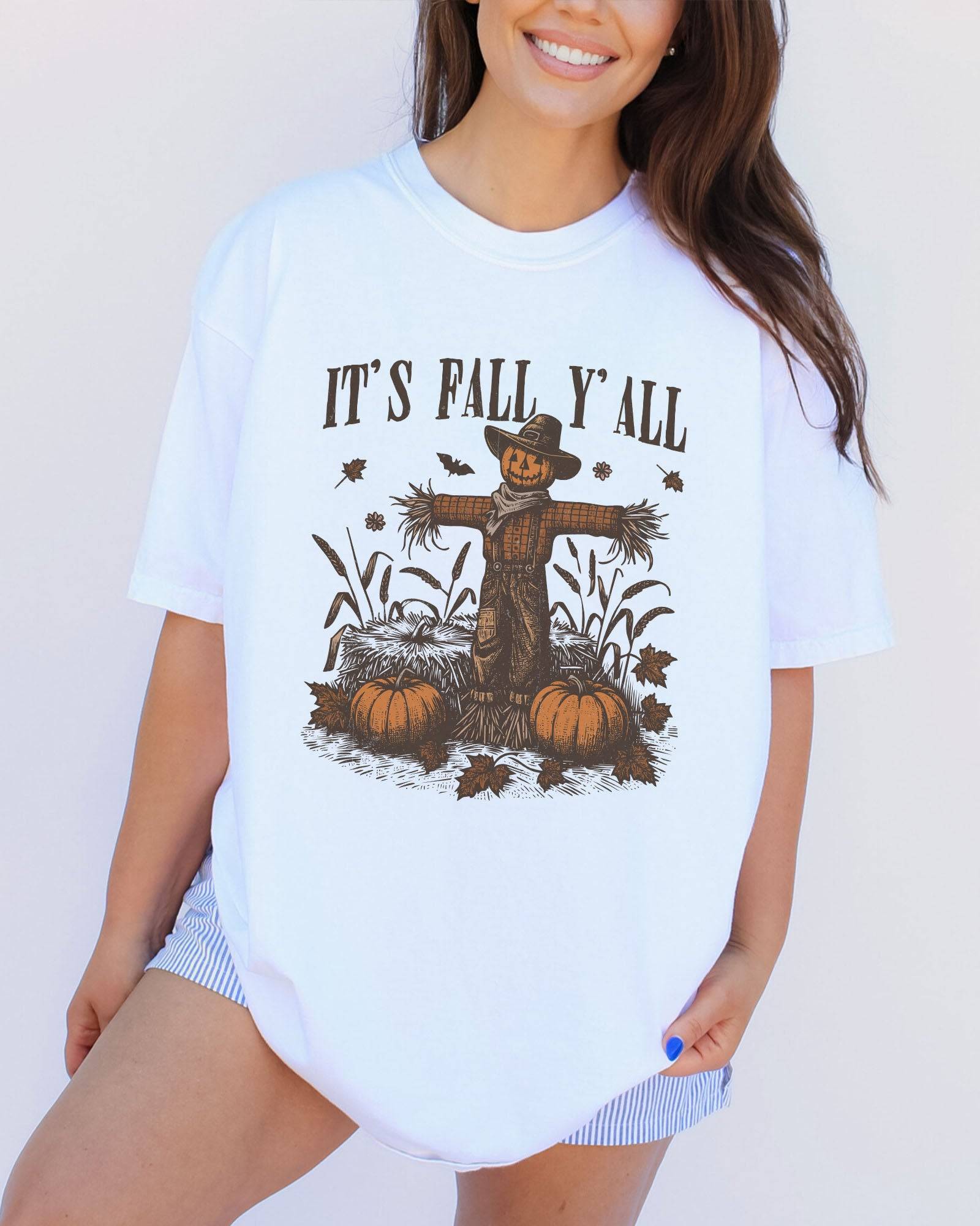 Model wearing white color shirt with 'It's Fall Y'all' graphic design