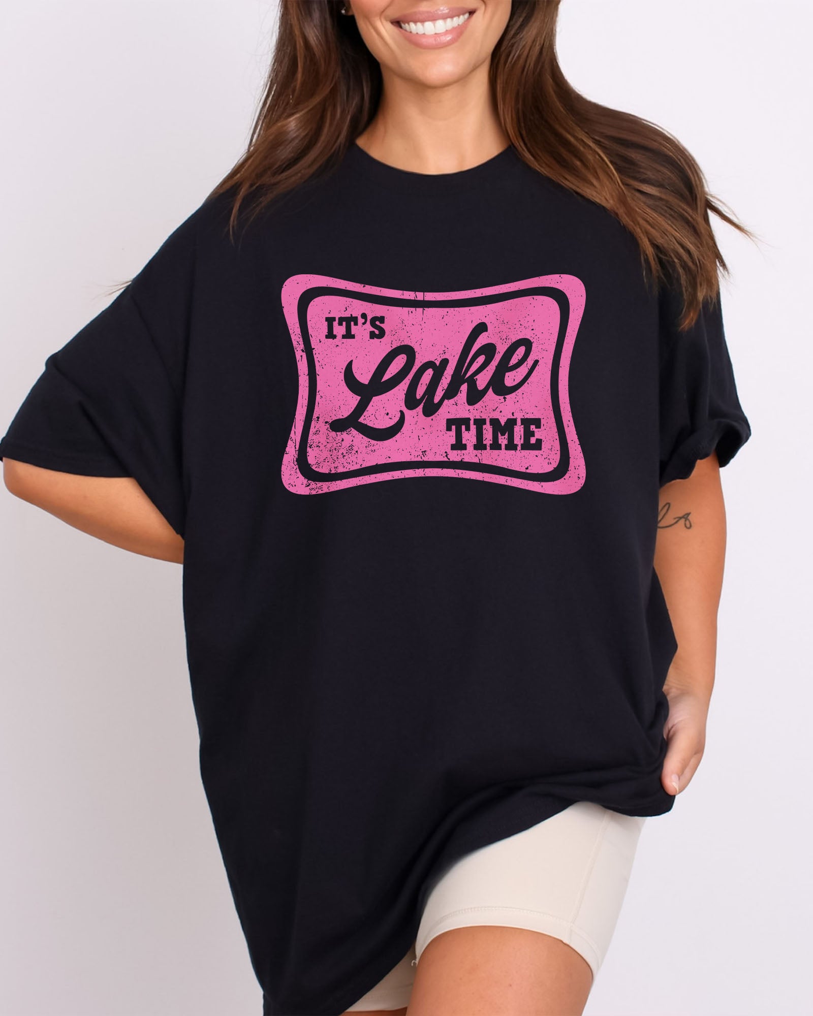 Model wearing black color shirt with 'It's Lake Time' graphic design