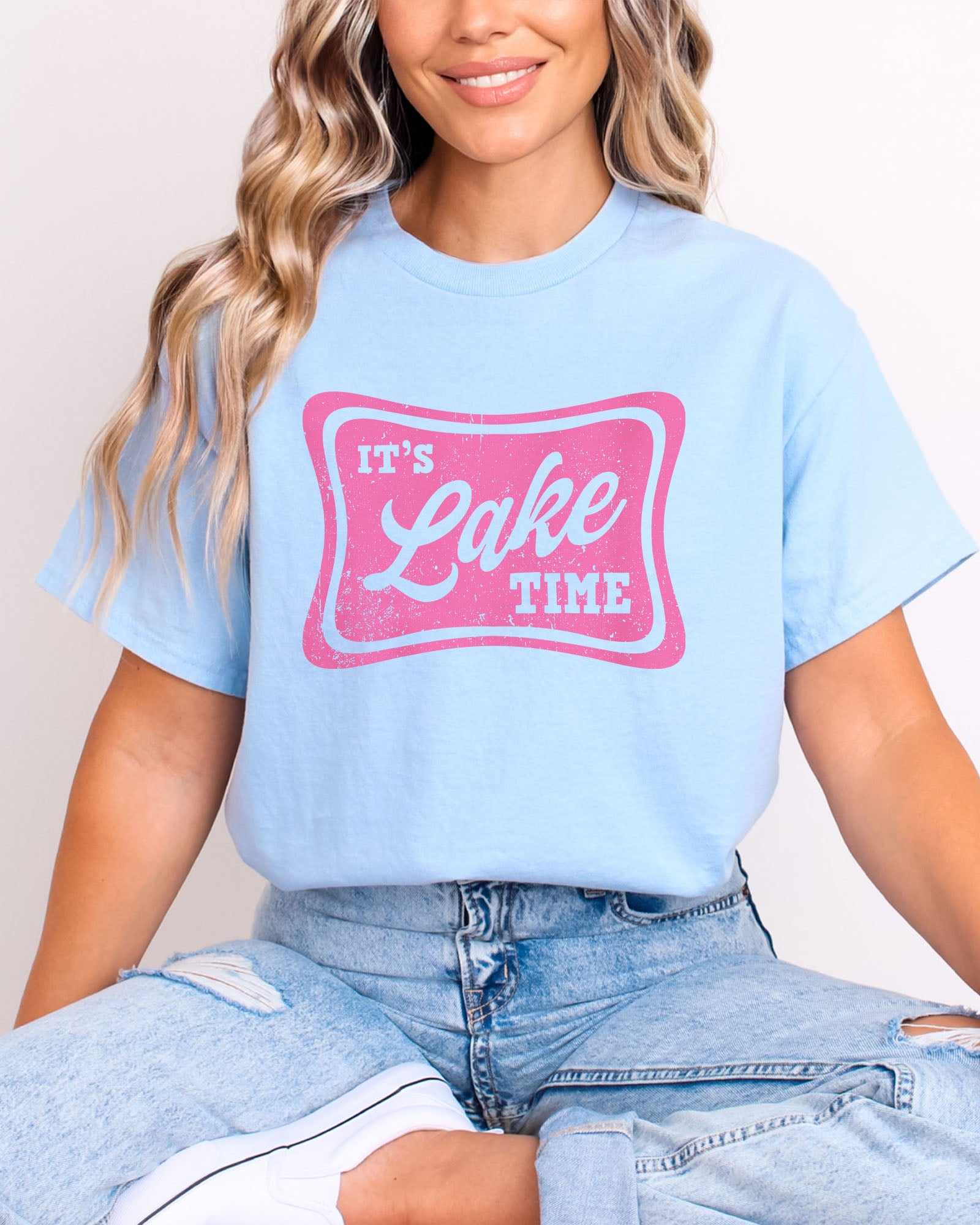Model wearing light blue color shirt with 'It's Lake Time' graphic design