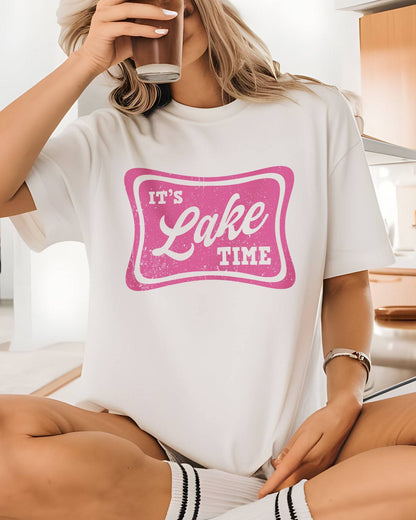 Model wearing white color shirt with 'It's Lake Time' graphic design
