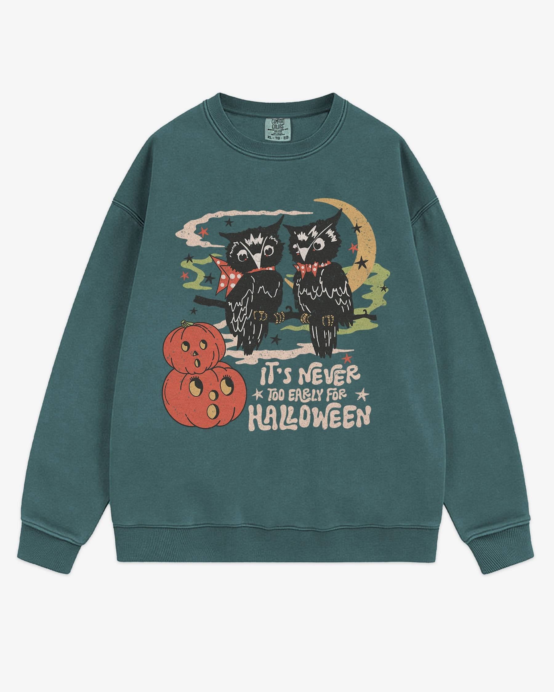 Flat lay blue spruce ‘It’s Never Too Early For Halloween’ sweatshirt with retro graphic of two owls, pumpkins, and night sky.