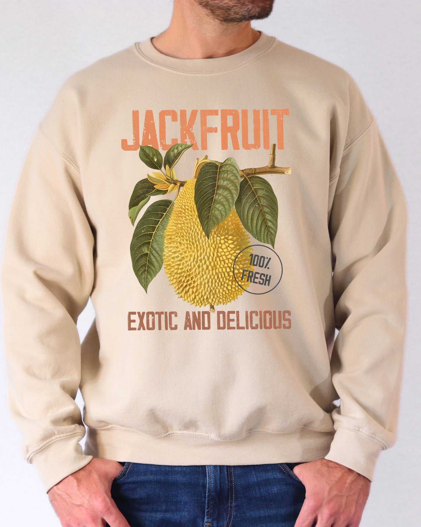 Model wearing sand color sweatshirt with jackfruit retro graphic design