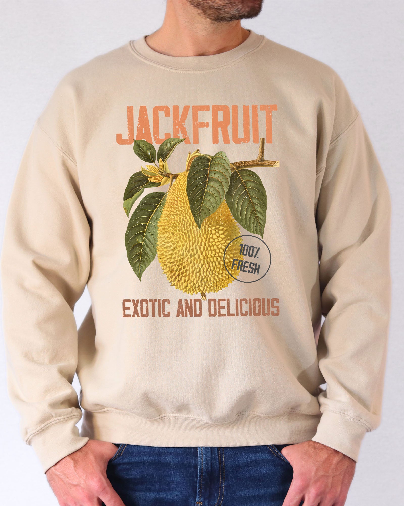 Model wearing sand color sweatshirt with jackfruit retro graphic design