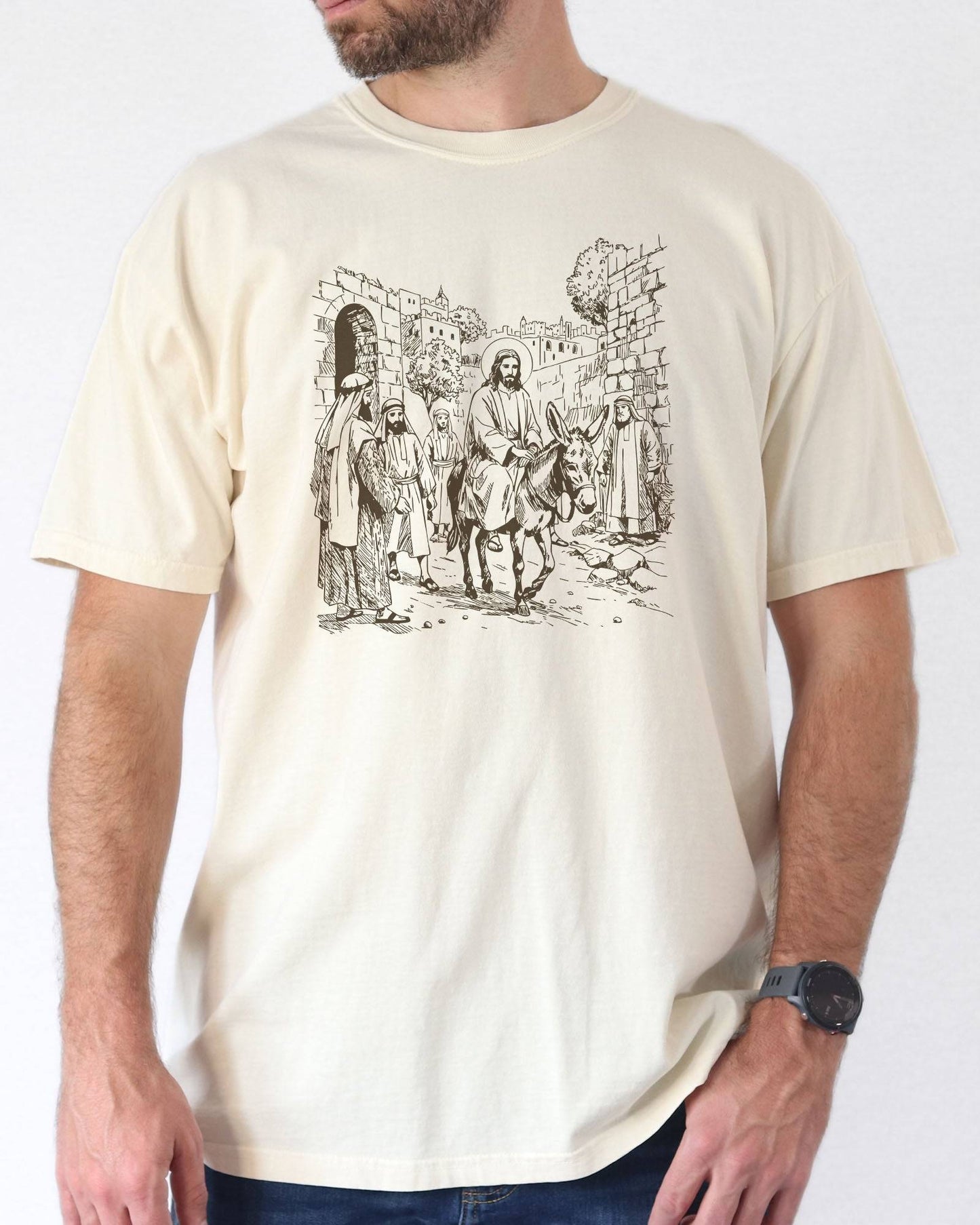 Man wearing ivory color shirt with Jesus Riding Donkey christian graphic design