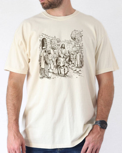 Man wearing ivory color shirt with Jesus Riding Donkey christian graphic design