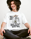 Model wearing white color shirt with 'Just About Done Dillin With Yall' funny cowboy skeleton pickle graphic design