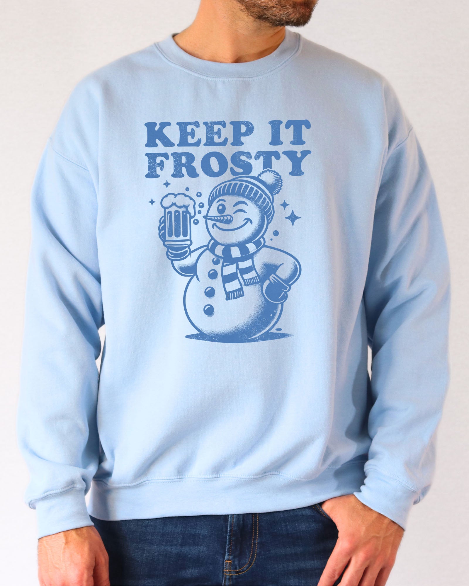 Model wearing light blue color sweatshirt with 'Keep It Frosty' snowman graphic design